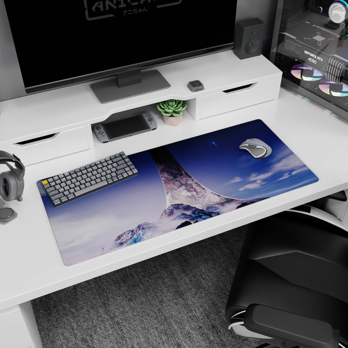 Desk pad 36x16 inches featuring snowy mountains beneath a huge ring-shaped spire in a quiet space sky.
