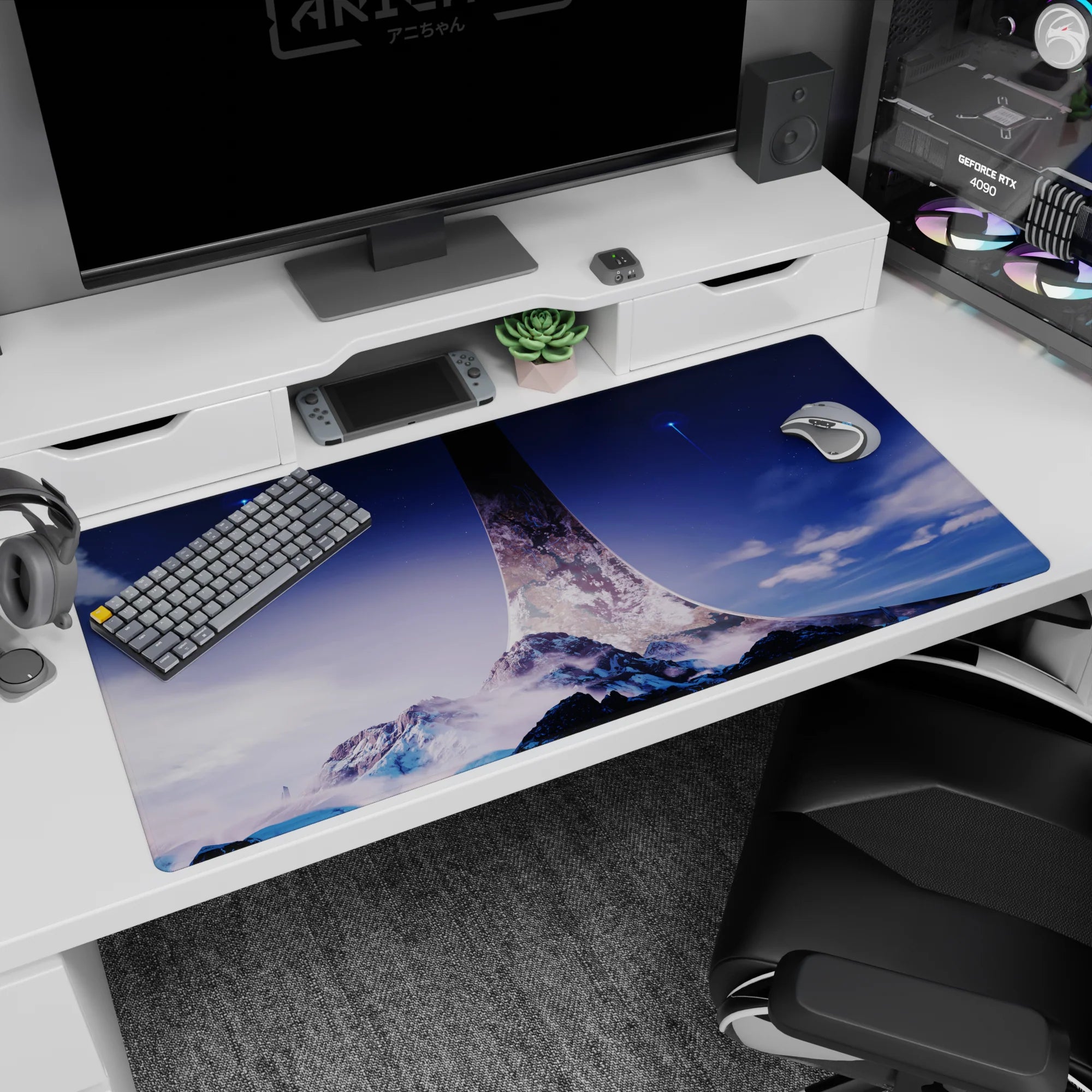 Ring-like spire over snowy mountains desk pad 40x20 inches under a deep blue starfield.
