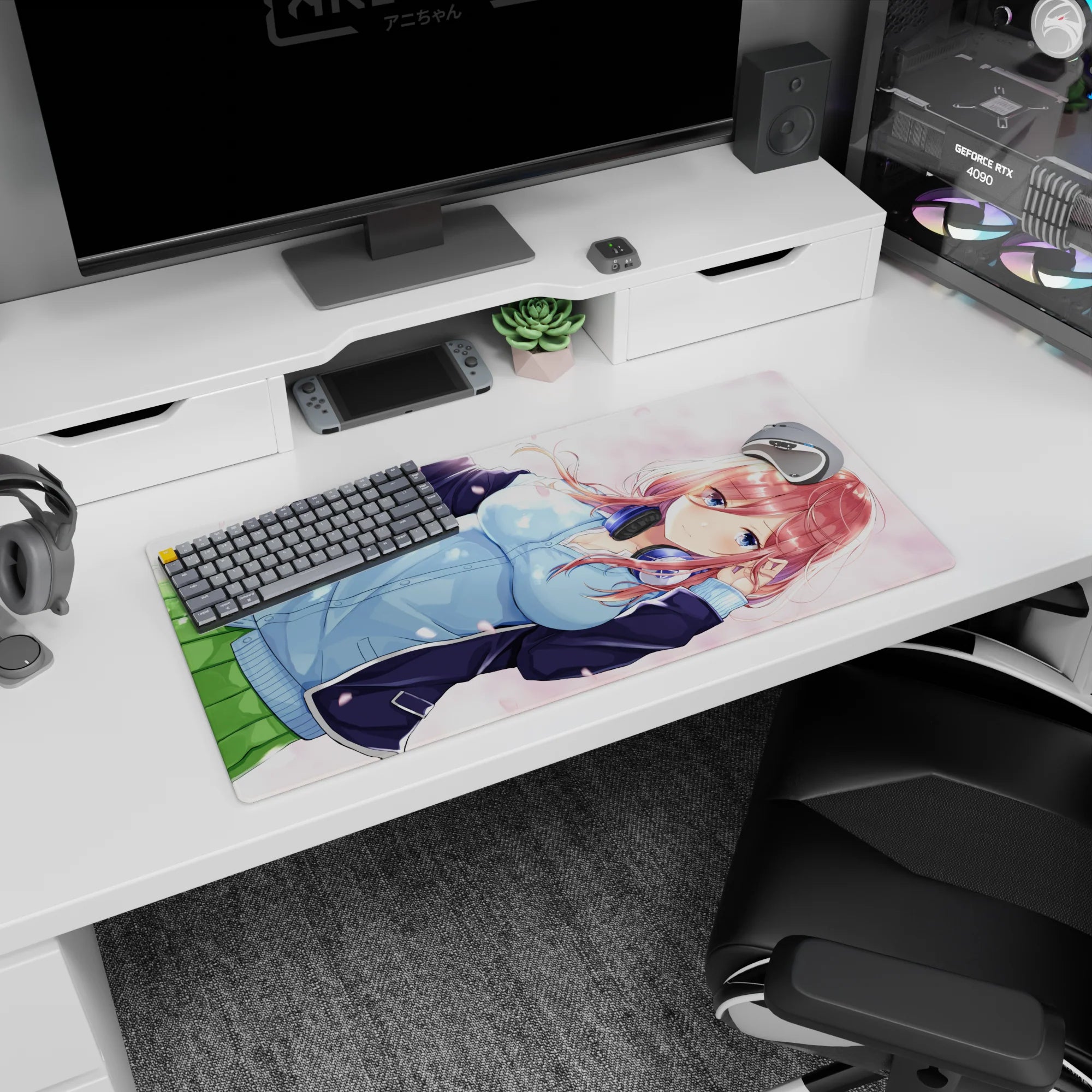 32x16 inches desk mat showing red-haired anime girl in hoodie with petals drifting, headphones at neck.