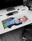 32x16 inches desk mat showing red-haired anime girl in hoodie with petals drifting, headphones at neck.