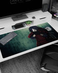 Madara Uchiha from Naruto Shippuden desk pad 40x20 inches, fingers in jutsu, rain-soaked scene.
