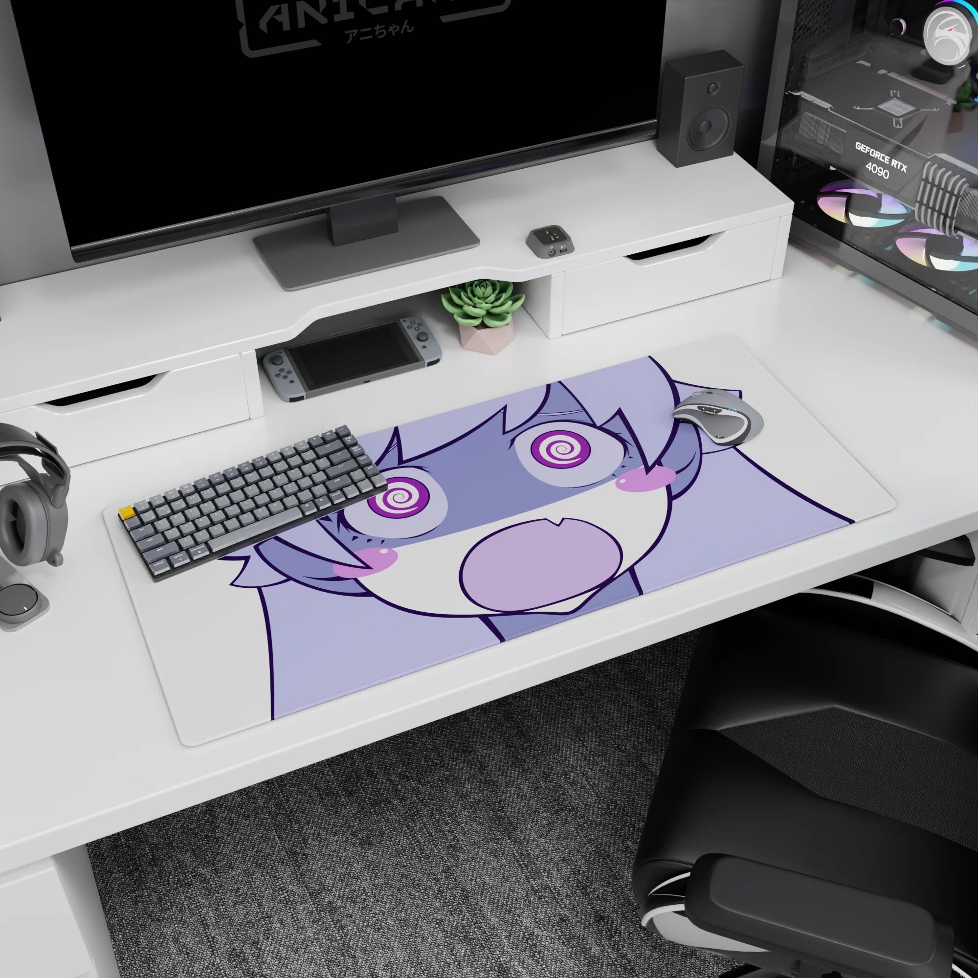 Chibi anime girl with puffy cheeks and wide spiral eyes staring at you on desk pad, 36x16 inches.