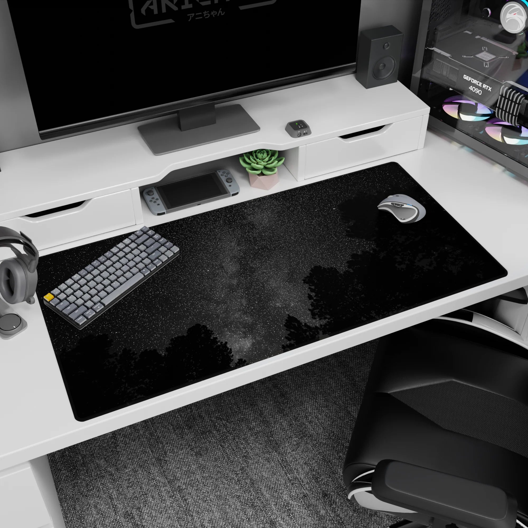 Glittery night sky with misty Milky Way stripe over treeline desk pad, 40x20 inches.