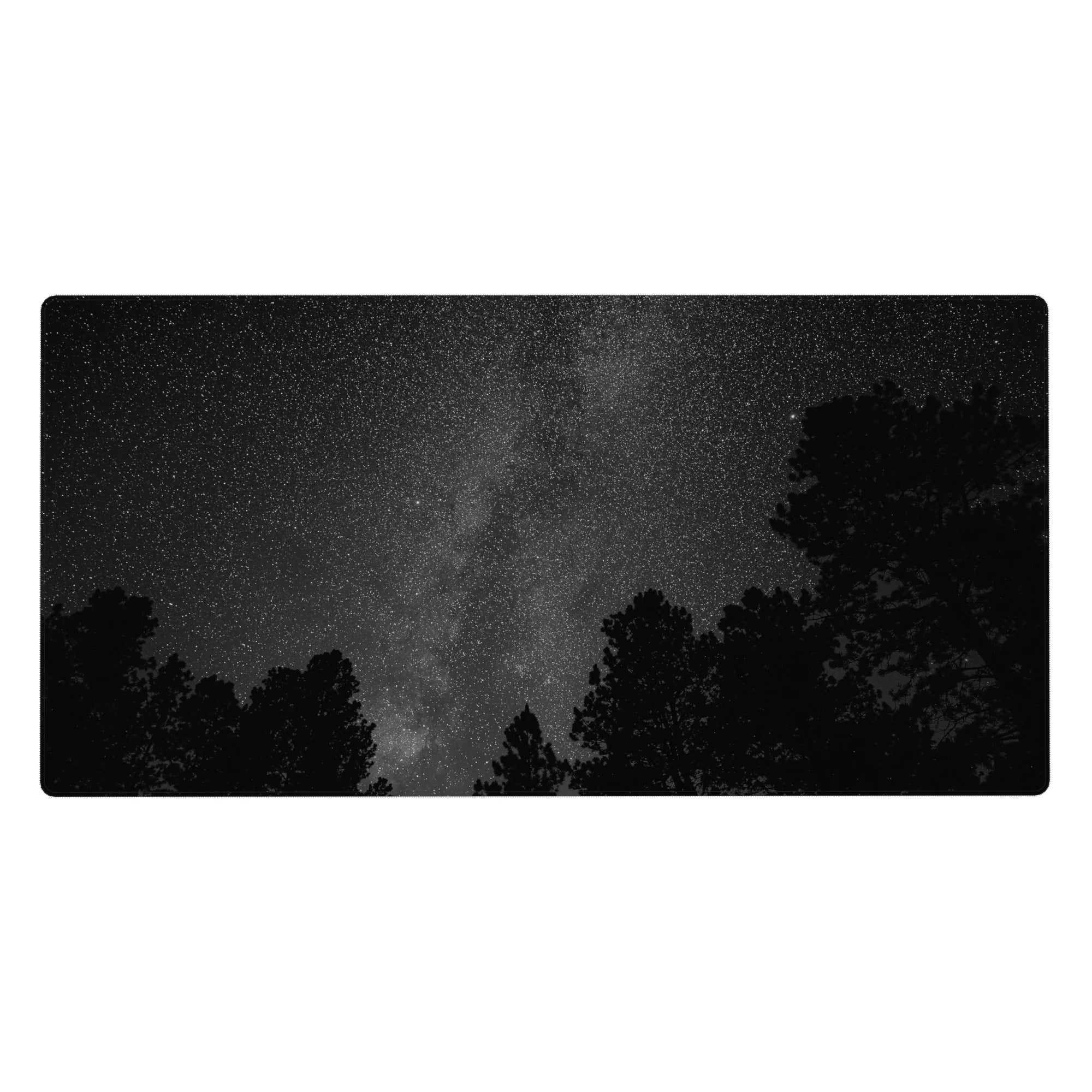 Forest silhouette under a starry Milky Way night sky desk pad, 40x20 inches.