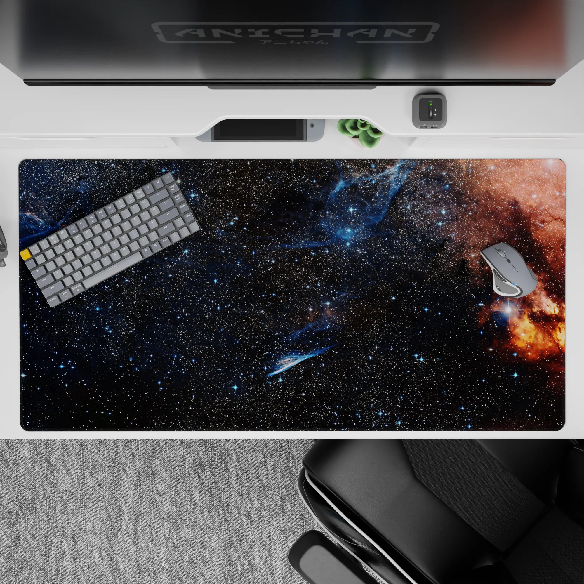 Midnight navy and inky black desk pad 40x20 inches with starry specks and a warm orange nebula.