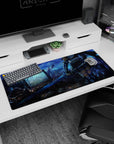 Anime warrior girl desk pad 36x16 inches, blade dragging through a wrecked screen junkyard at twilight.