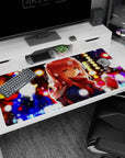Anime girl with red hair and amber eyes in a scarf, snowy night city backdrop desk pad 40x20 inches.