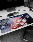 Pink-haired anime girl clinging to fox-eared black-haired girl desk pad 40x20 inches over snowy water.