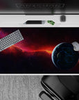 Moody cosmic desk pad 40x20 inches in smoky purples, midnight tones, and a fiery orange nebula.