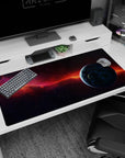 Starfield desk pad 40x20 inches featuring a blue planet at the edge and a comet-like orange ribbon.