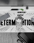 High-contrast black-and-white desk pad, stubborn pouty anime vibe with DETERMINATION text, 40x20 inches.