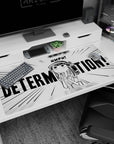 Pouty anime girl with cap and ponytail, tiny fists up, DETERMINATION poster-style desk pad, 40x20 inches.