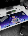 Shy twin-tail anime girl with floating hair and ruby eyes on a 40x20 inches desk pad, petals drifting in space.
