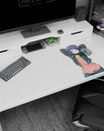 40x20 inches anime desk pad showing a drowsy girl stretching, cheek marks, short indigo hair, earbuds hanging.