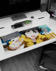 Winking anime girl in yellow hoodie flashing a peace sign on a 36x16 inches desk pad.