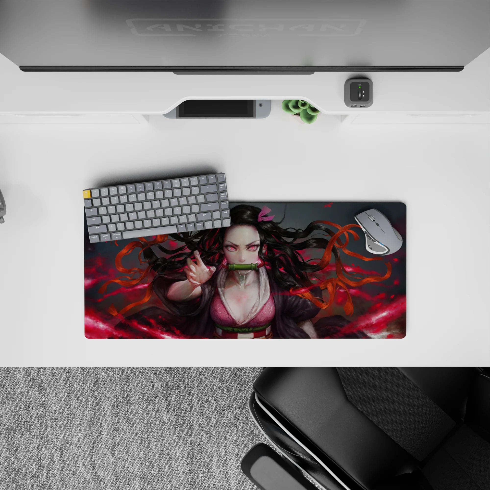Anime mouse pad 28x12 inches featuring Nezuko with fiery red background, capturing her intense pink-eyed gaze and dynamic hair.