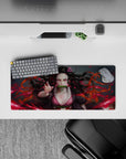 Anime mouse pad 28x12 inches featuring Nezuko with fiery red background, capturing her intense pink-eyed gaze and dynamic hair.
