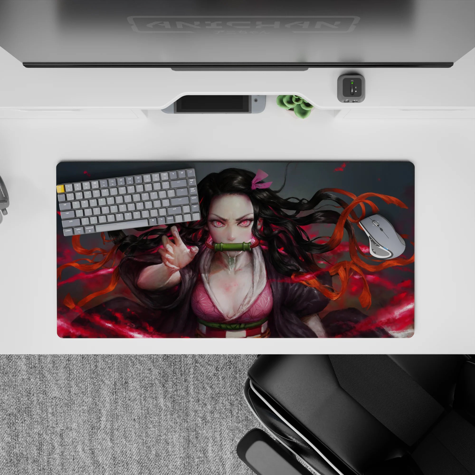Nezuko anime mouse pad 32x16 inches with fierce design, pink eyes, and dynamic hair against a blazing red background.