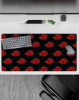 Charcoal black and candy-red cloud emblems anime desk mat, 32x16 inches, bold Naruto vibe.