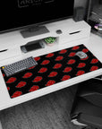 Naruto Shippuden Akatsuki symbols desk pad 36x16 inches, repeating red clouds on black.