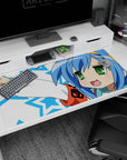 Konata Izumi Lucky Star desk pad 40x20 inches, blushy grin and victory pose on blue stars.
