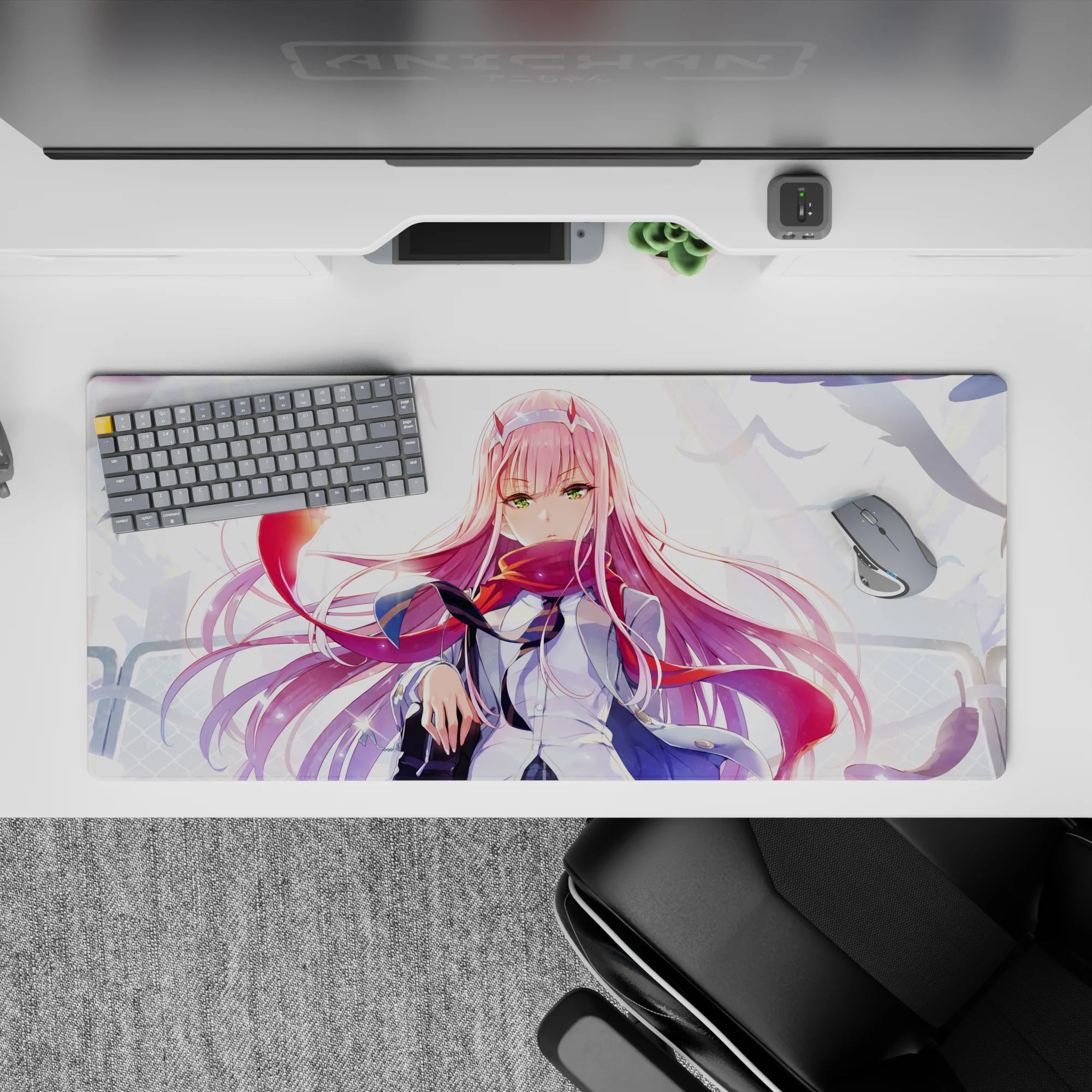 Powerful 36x16 desk pad with Zero Two’s fierce emerald eyes, flowing pink hair, and dynamic windswept background