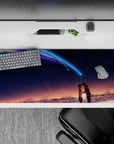 36x16 inches anime desk pad in sunset-to-midnight hues with neon blue-violet comet, dreamy romance vibe.