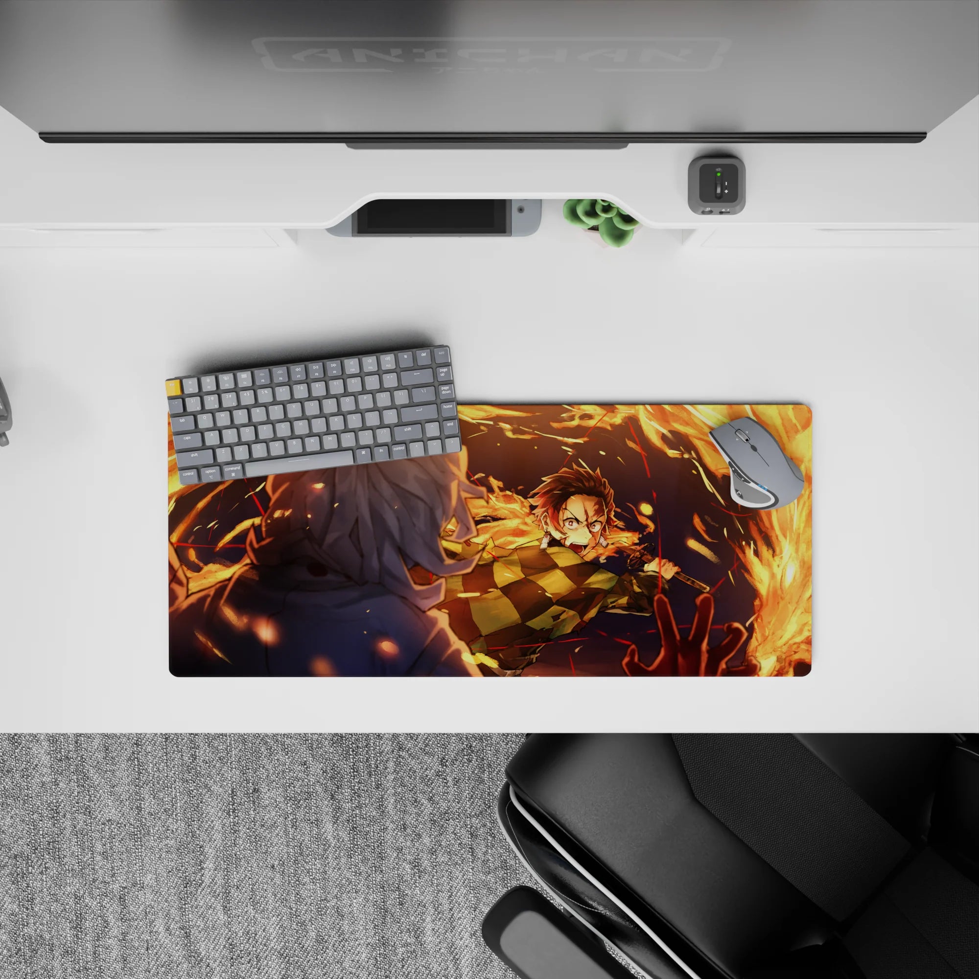 Anime mouse pad 28x12 inches featuring Tanjiro Kamado mid-strike with blazing orange arcs against a deep blue night.