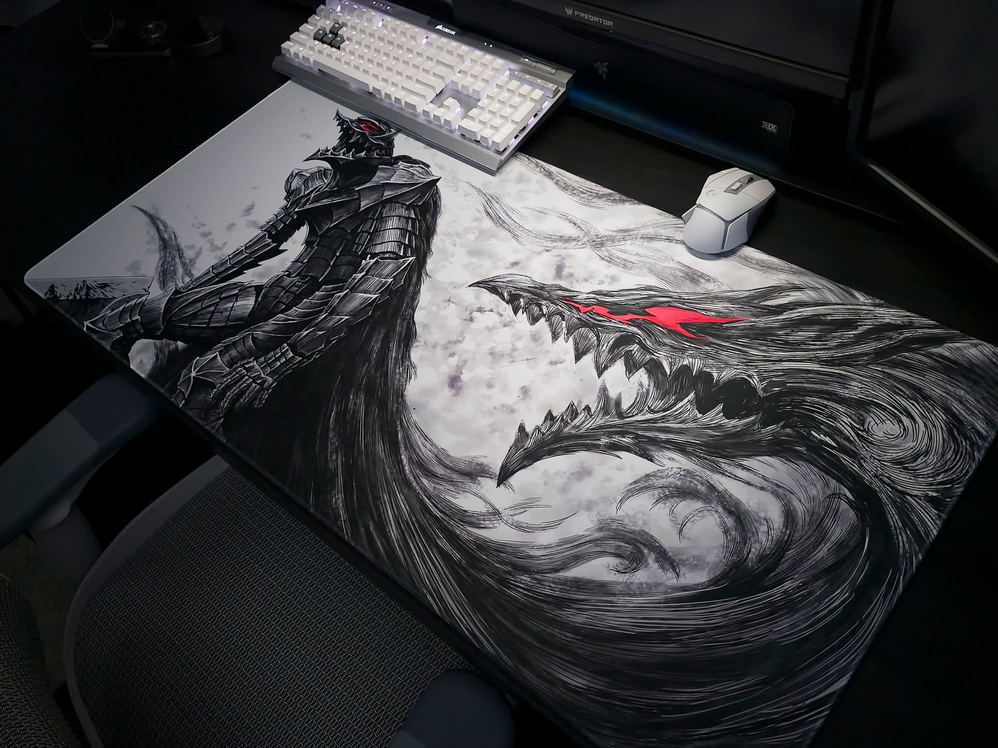 Berserk themed deskmat on table. 