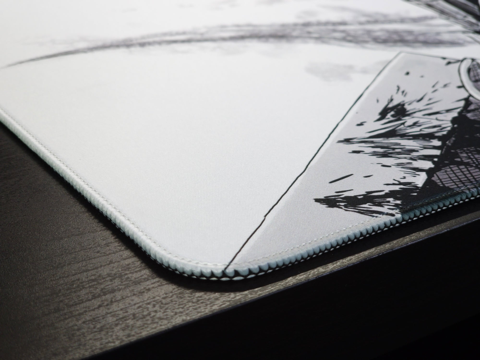 Close-up of the stitched edge and smooth fabric surface of an anime desk mat, highlighting the premium craftsmanship and precision stitching.
